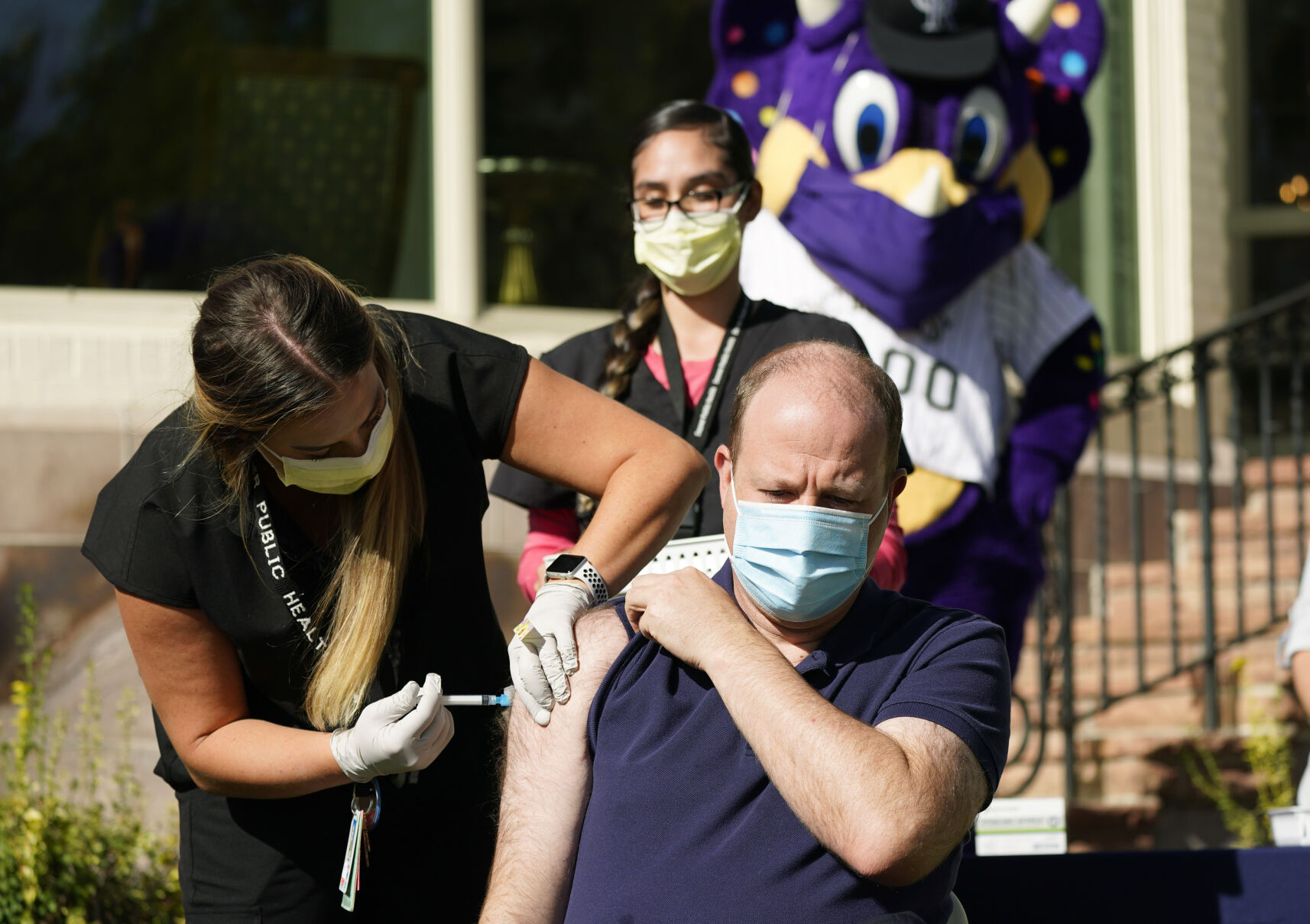 Polis gets flu vaccine on governor’s mansion lawn