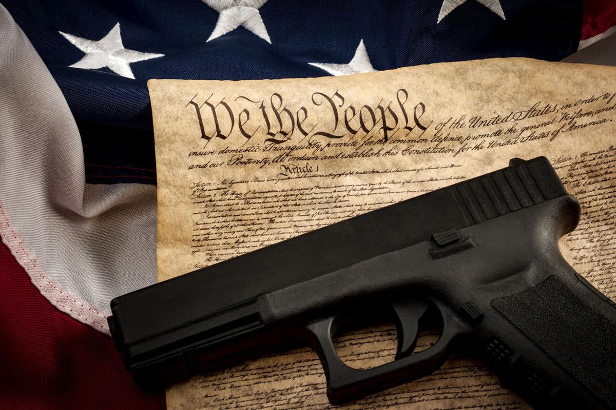 American constitution, USA flag and a handgun