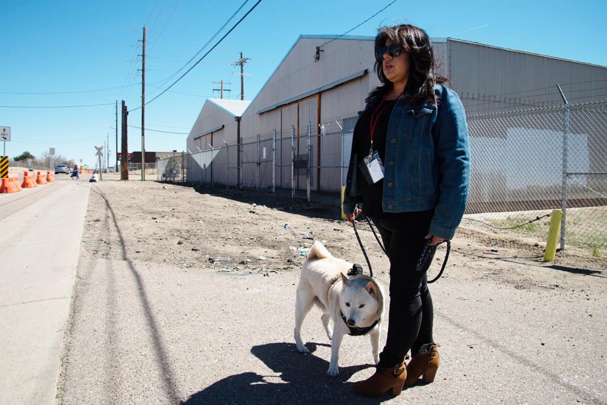 Tanya Chavez walks with her dog Sumo around the site
