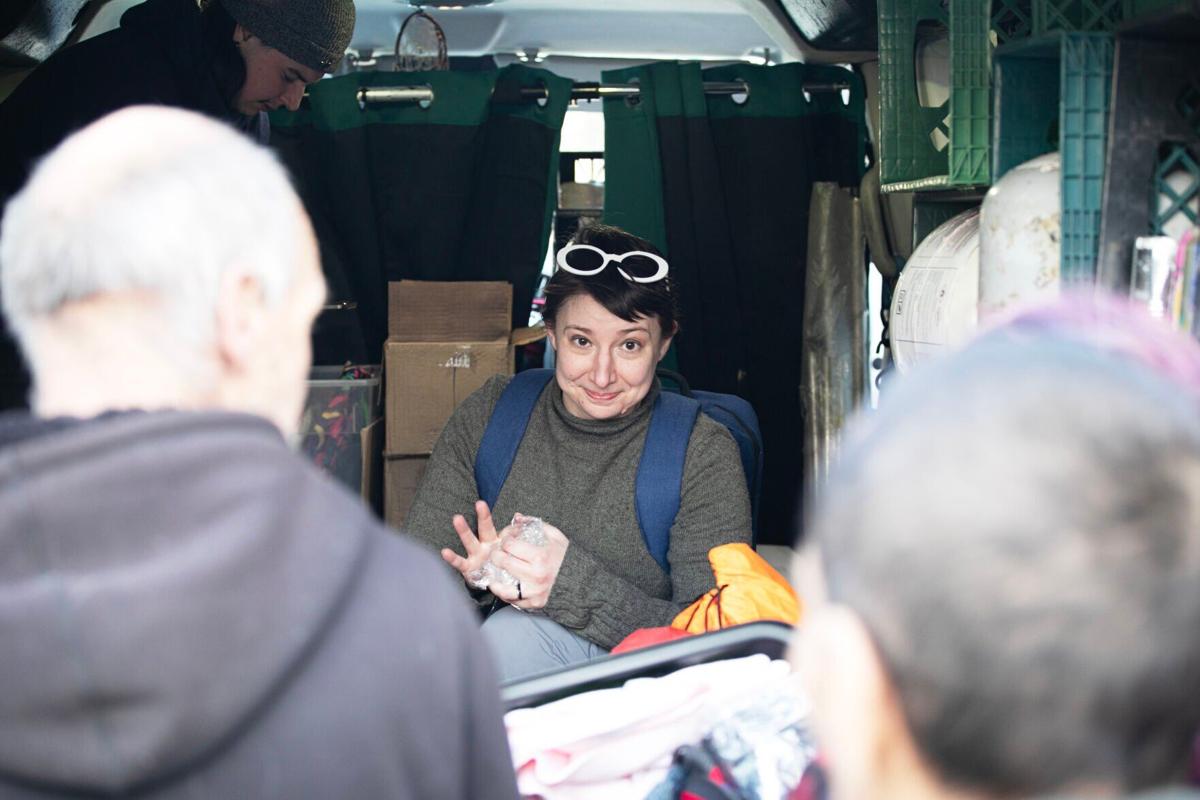 Jen Kolic, center, a volunteer with Mutual Aid Monday