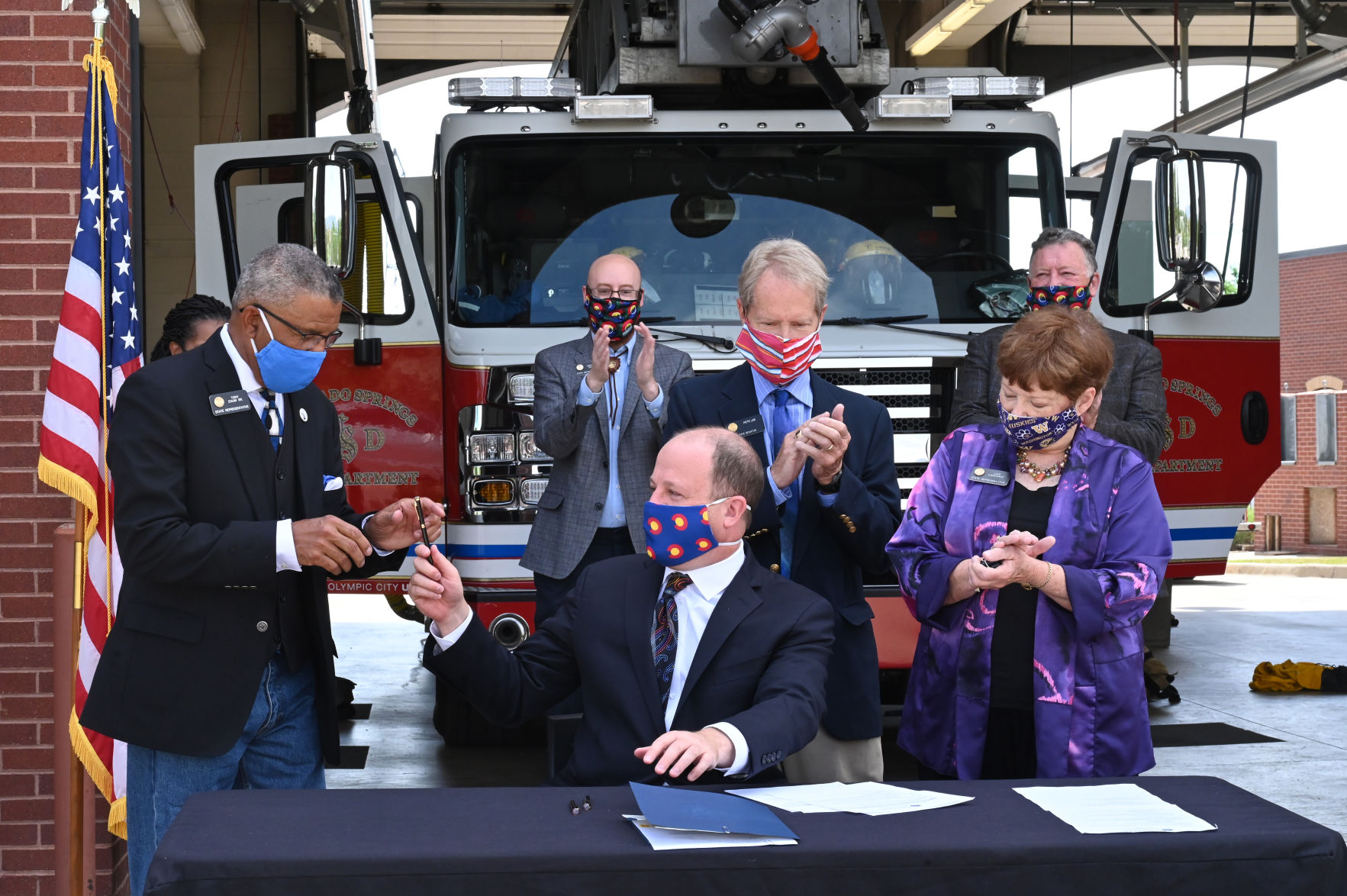 Polis signs bills at Colorado Springs fire station to protect state residents from toxic foam effects