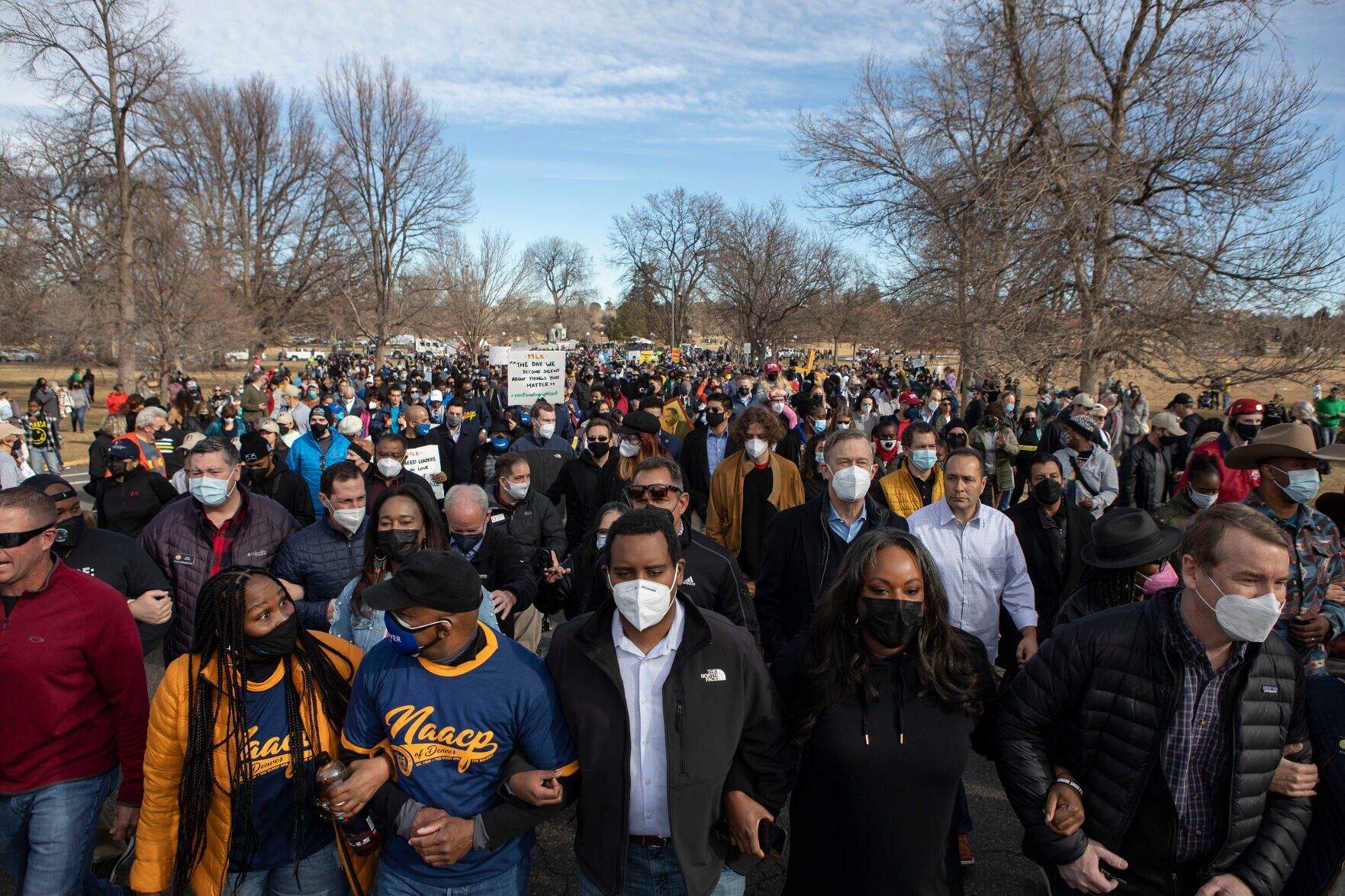 Polis, political leaders join hundreds in march through Denver for MLK Day