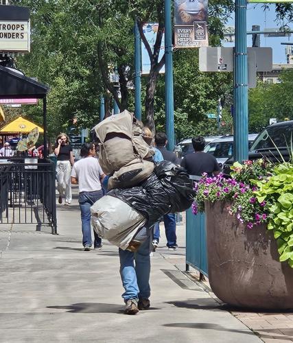 Homeless man walking downtown