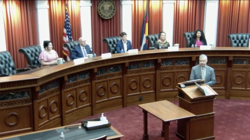 Gilbert M. Román speaks in Supreme Court courtroom