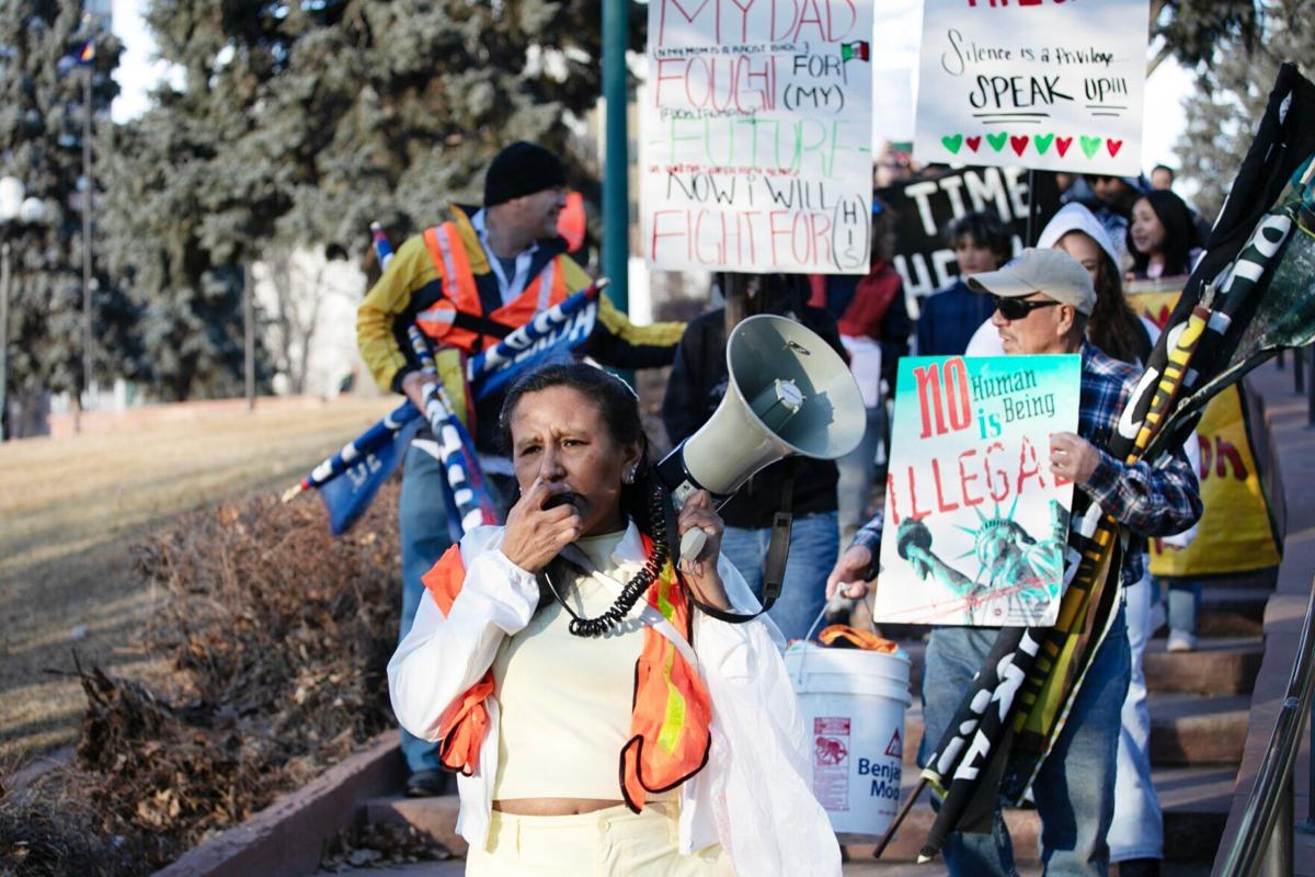 Jeanette Vizguerra leads chants through a megaphone