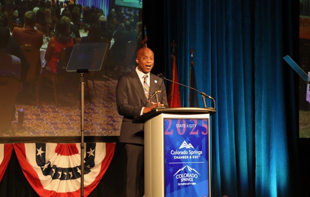 Mayor Yemi Mobolade stands behind a podium on stage for his 2025 State of the City address