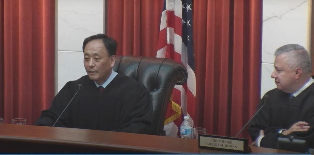 FILE PHOTO: Judge David H. Yun speaks on June 30, 2022 after his formal swearing-in to the Colorado Court of Appeals, with Chief Judge Gilbert M. Román at right.