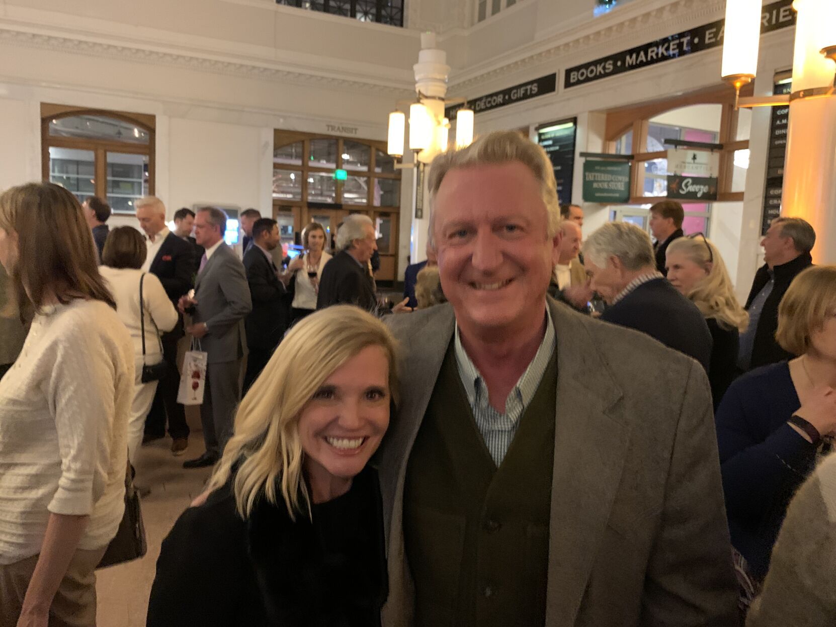 two people standing together at a party