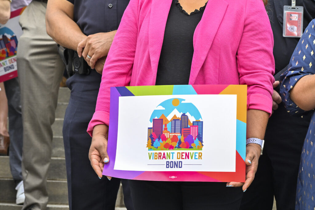 a woman's hands holding a sign