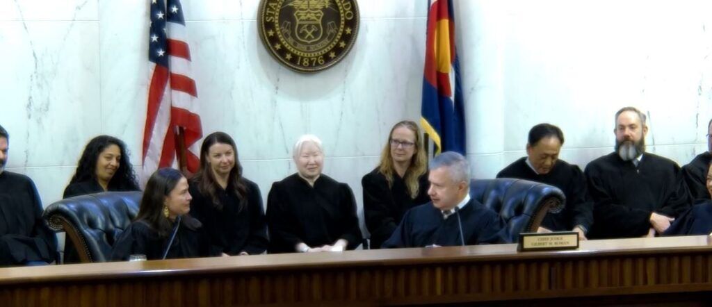 Colorado Court of Appeals Chief Judge Gilbert M. Román, at right, speaks to Judge Melissa C. Meirink, at left, during her ceremonial swearing-in on Feb. 27, 2025.