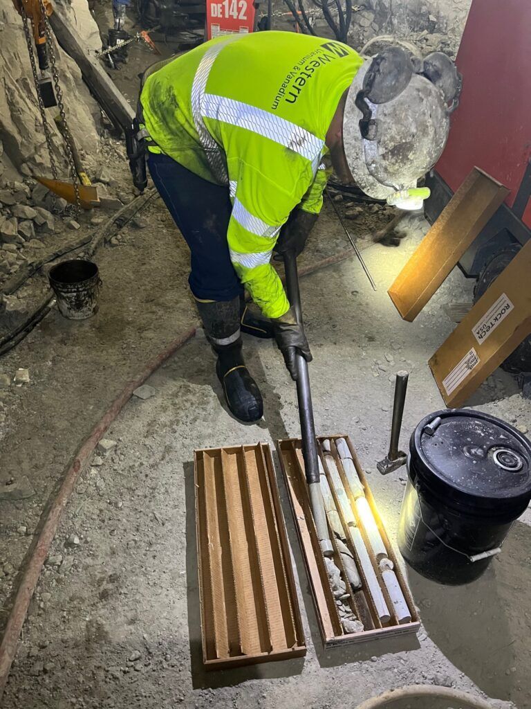 Mine worker boxes up drilling cores for analysis
