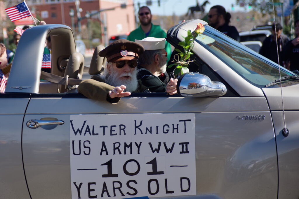 A world war II veteran waves to the crowd during the Veterans Day Parade on Saturday Nov. 8, 2025.