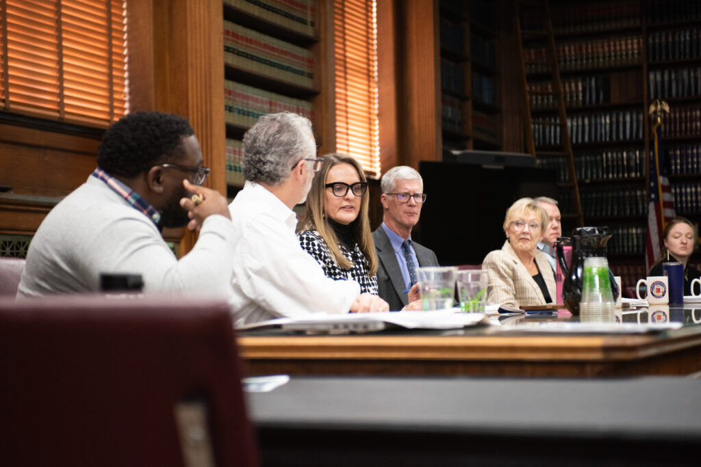 a group of people in a board room