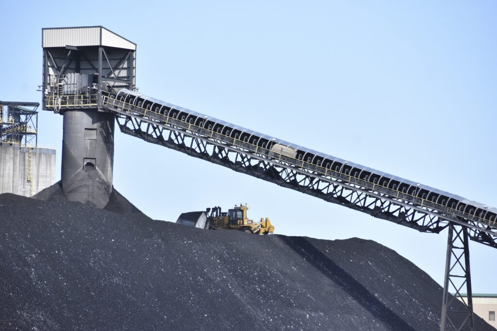A heavy machinery operator is seen moving coal at Signal Peak Energy's Bull Mountains Mine, on May 21, 2025, near Roundup, Montana. (AP Photo/Matthew Brown)