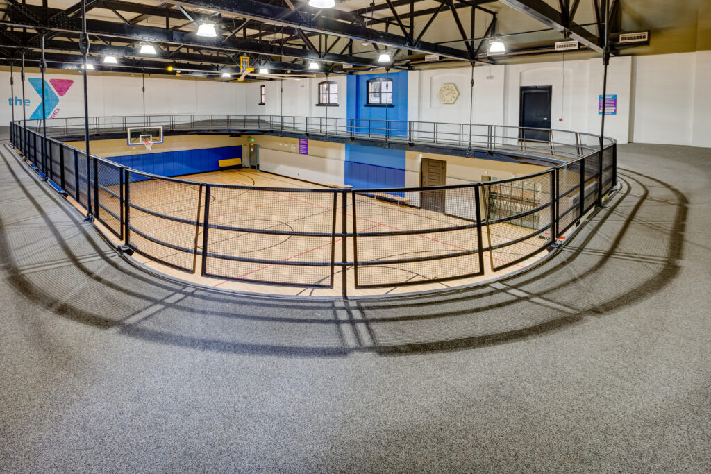 a gymnasium with an elevated track
