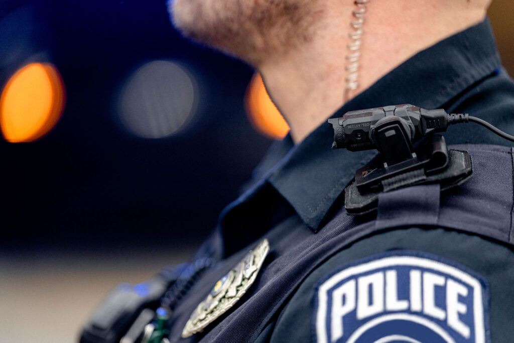 a police with a shoulder-mounted body cam