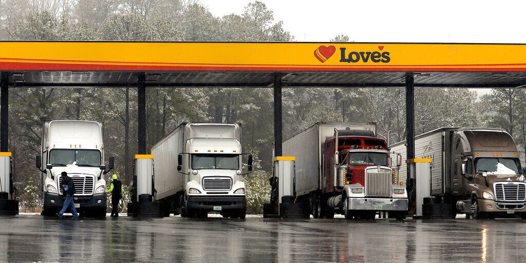 truck drivers stop at a gas station in Emerson, Ga., north of metro Atlanta, to fill up their tractor trailer rigs.