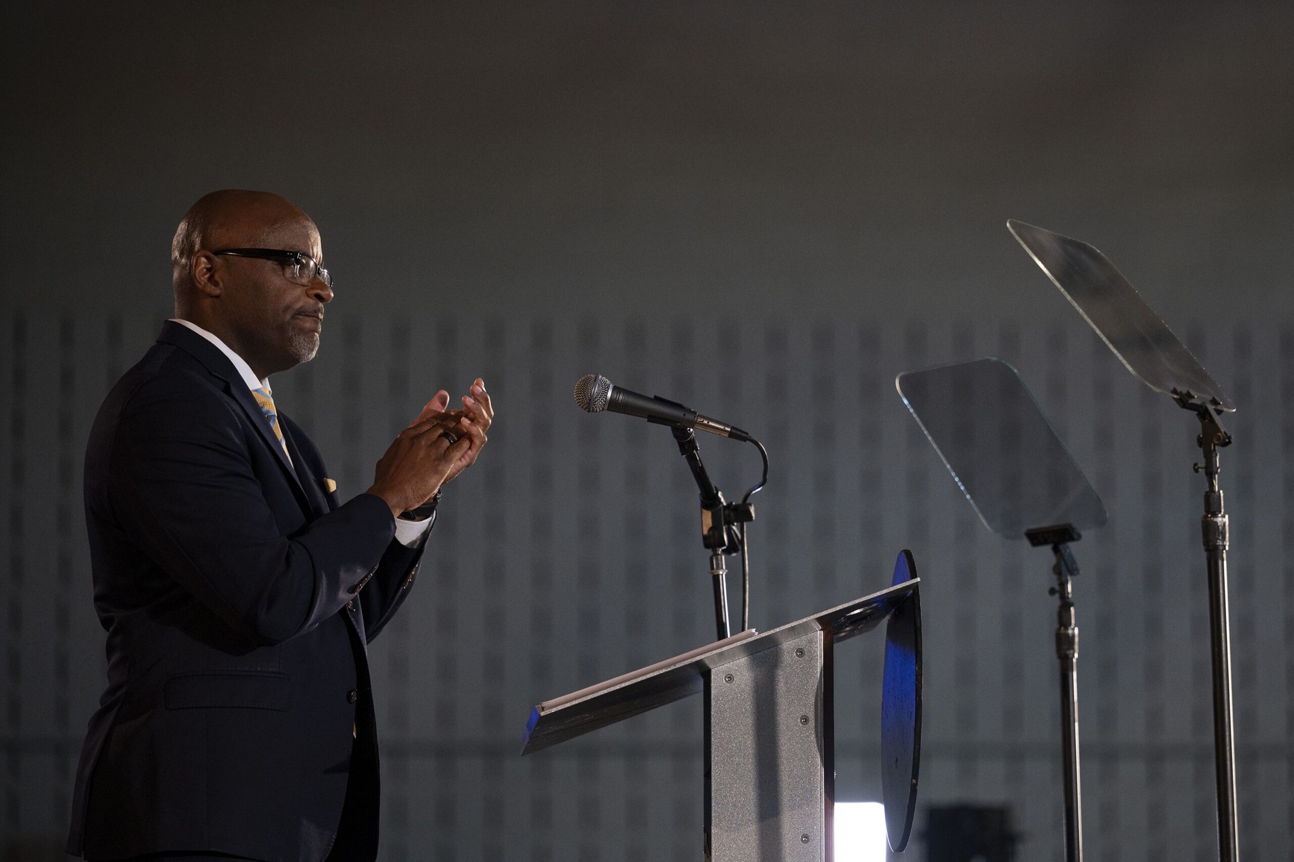 a politician stands behind a podium