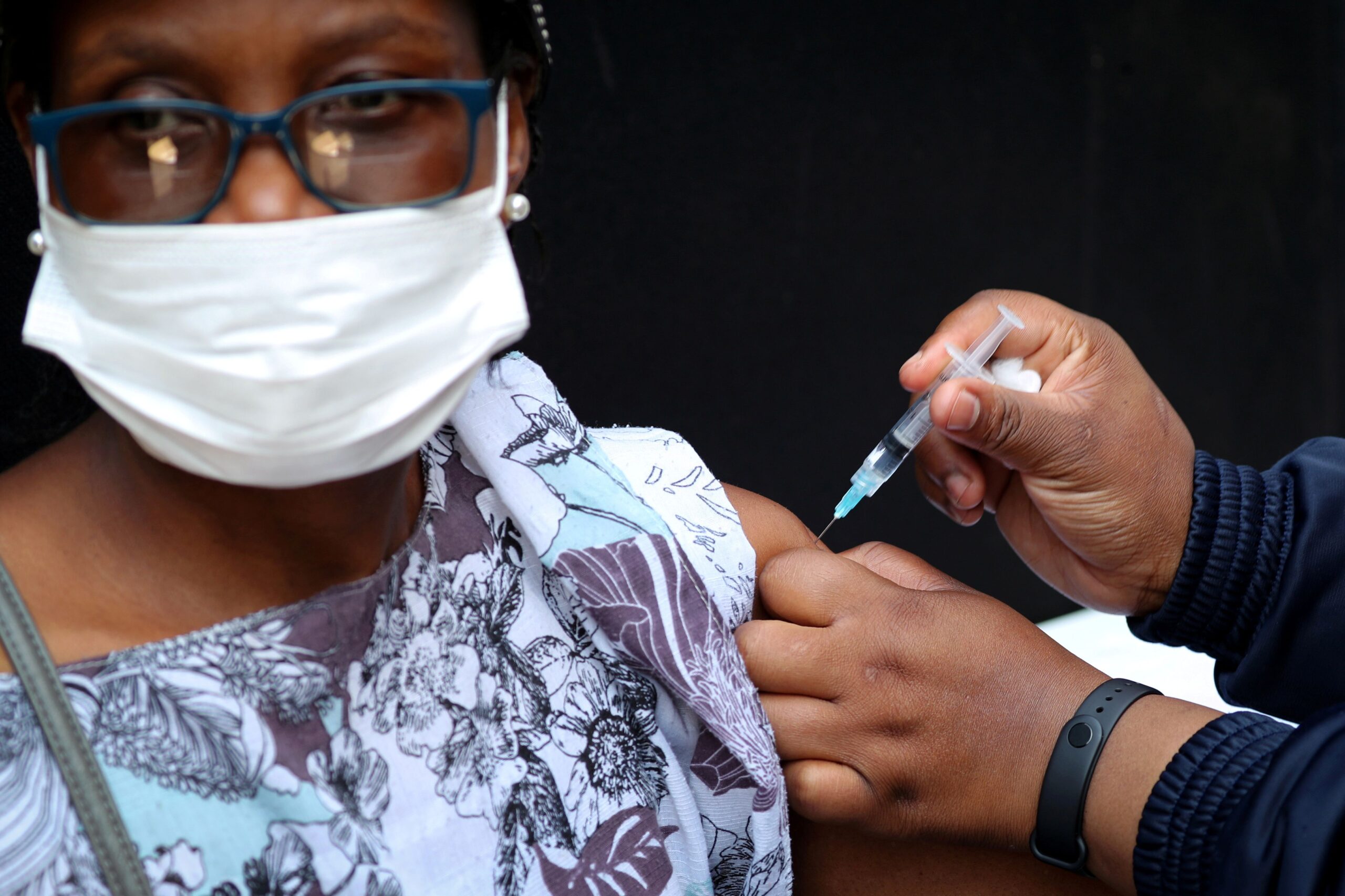 FILE PHOTO: A healthcare worker administers the Johnson and Johnson coronavirus disease (COVID-19) vaccination to a woman in Houghton, Johannesburg, South Africa, August 20, 2021. REUTERS/ Sumaya Hisham/File Photo