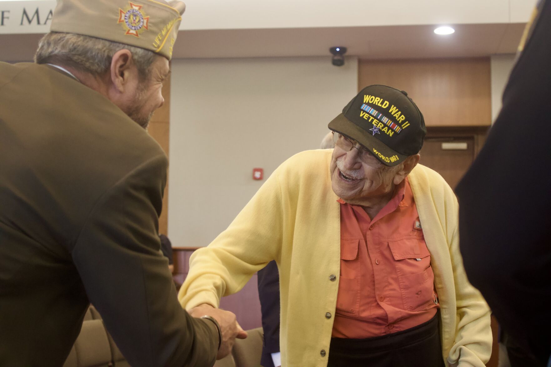 101-year-old World War ll veteran Staff Sgt. Howard A. Berger (right) greets a fellow veteran before receiving a Douglas County Hall of Fame Commissioner Challenge Coin at the Douglas County Government building on Tuesday, March 11 in Castle Rock, Colorado. (Noah Festenstein
noah.festenstein@denvergazette.com)