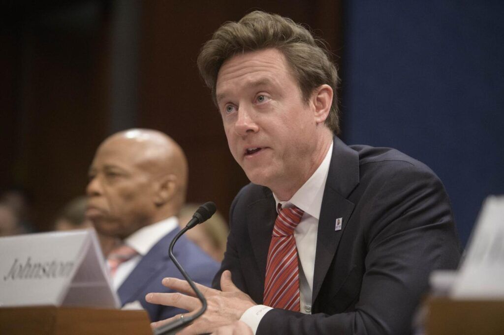 a man speaking behind a microphone