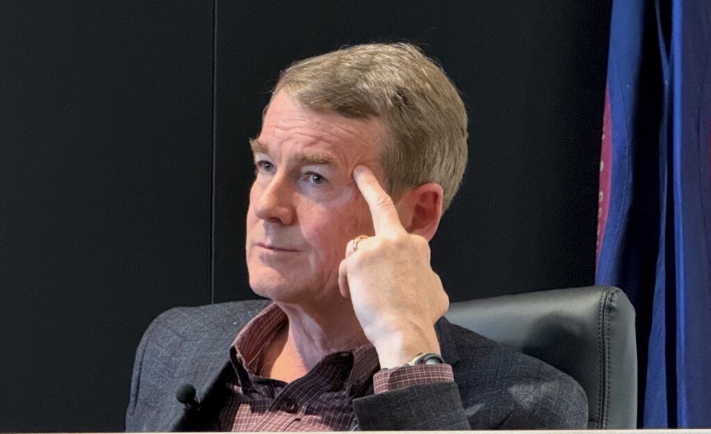 Democratic gubernatorial candidate U.S. Sen. Michael Bennet listens during a candidate forum with primary opponent Attorney General Phil Weiser sponsored by the Colorado Young Democrats on Saturday, Jan. 10, 2026, at the International Brotherhood of Electrical Workers Local 68 hall in Denver. (Ernest Luning/Colorado Politics)