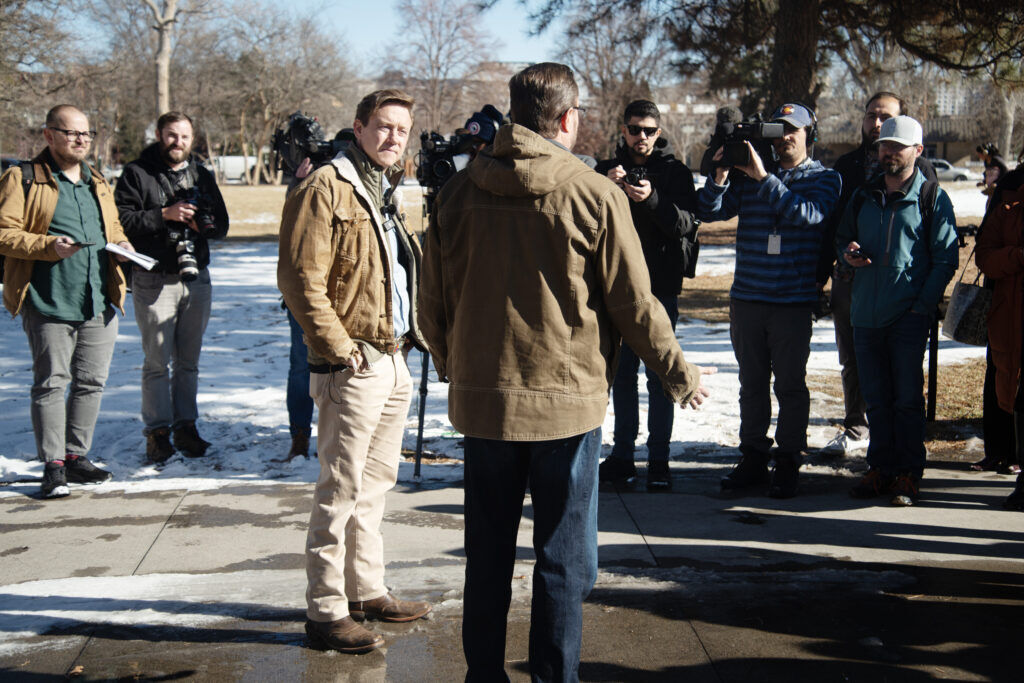 men talking in a park