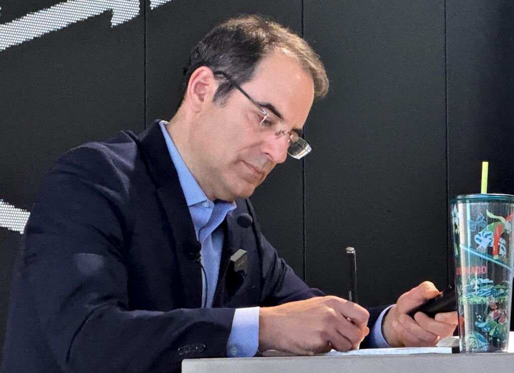 Democratic gubernatorial candidate Attorney General Phil Weiser takes notes during a joint appearance with primary rival U.S. Sen. Michael Bennet at a forum sponsored by the Colorado Young Democrats on Saturday, Jan. 10, 2026, at the International Brotherhood of Electrical Workers Local 68 hall in Denver. (Ernest Luning/Colorado Politics)