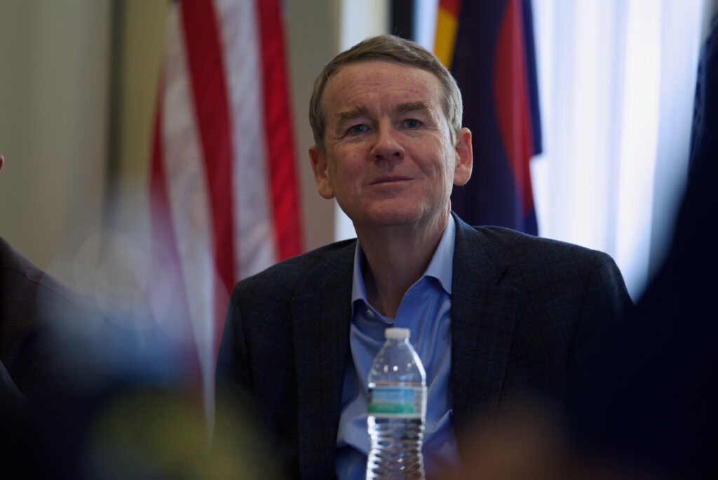 Sen. Michael Bennet listens to a small group of veterans. He sought feedback on certain policies related to veteran care as part of his campaign to become governor.