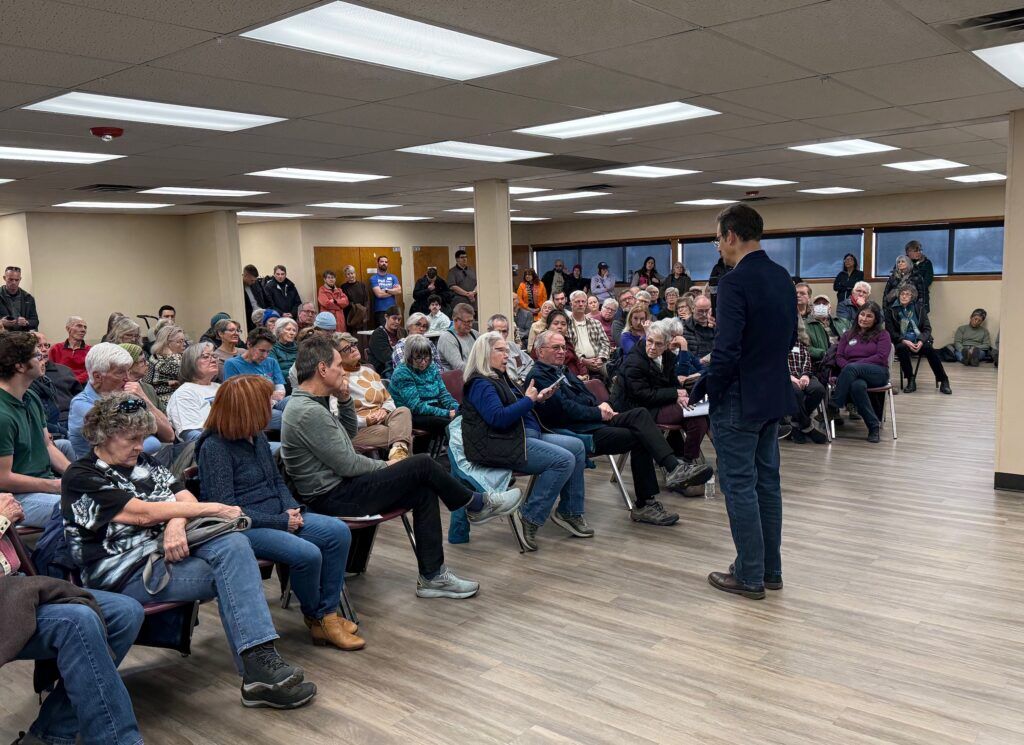 Colorado Attorney General Phil Weiser, standing, a Democratic gubernatorial candidate, speaks to the crowd at a campaign town hall on Jan. 24, 2026, at Charles Whitlock Recreation Center in Lakewood. (Ernest Luning/Colorado Politics)