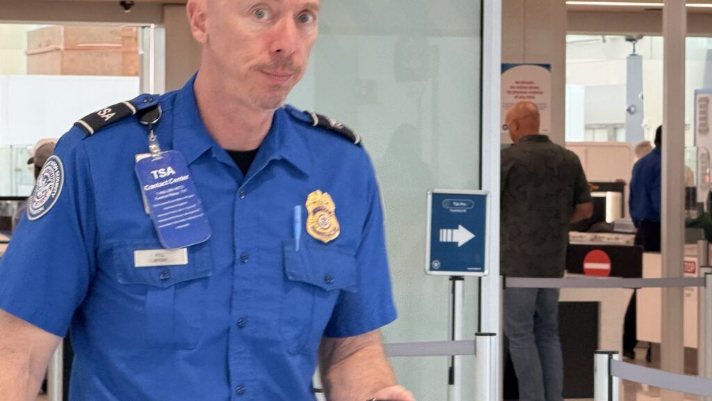 an airport security agent exits a sterile area at Denver International Airport.
