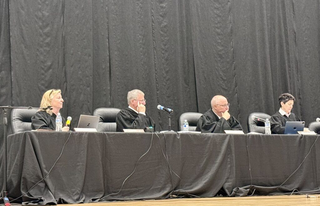 Justices Maria E. Berkenkotter, Richard L. Gabriel, Brian D. Boatright, and Chief Justice Monica M. Márquez listen to oral arguments at Holyoke Junior/Senior High School in Holyoke, Colo. on April 16, 2026 as part of the "Courts in the Community" program. Michael Karlik, Colorado Politics.