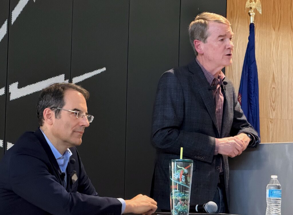 Democratic gubernatorial candidates Attorney General Phil Weiser, left, and U.S. Sen. Michael Bennet take part in forum sponsored by the Colorado Young Democrats on Saturday, Jan. 10, 2026, at the International Brotherhood of Electrical Workers Local 68 hall in Denver. (Ernest Luning/Colorado Politics)