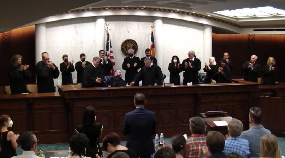 FILE PHOTO: Attendees applaud following the formal swearing-in of Judge W. Eric Kuhn to the Colorado Court of Appeals on July 22, 2022.