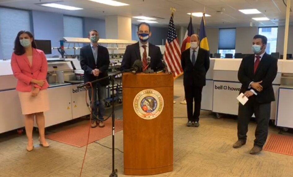 U.S. Sen. Michael Bennet, left, Attorney General Phil Weiser, center, Gov. Jared Polis are seen at a news conference in December 2024. (Gazette file)