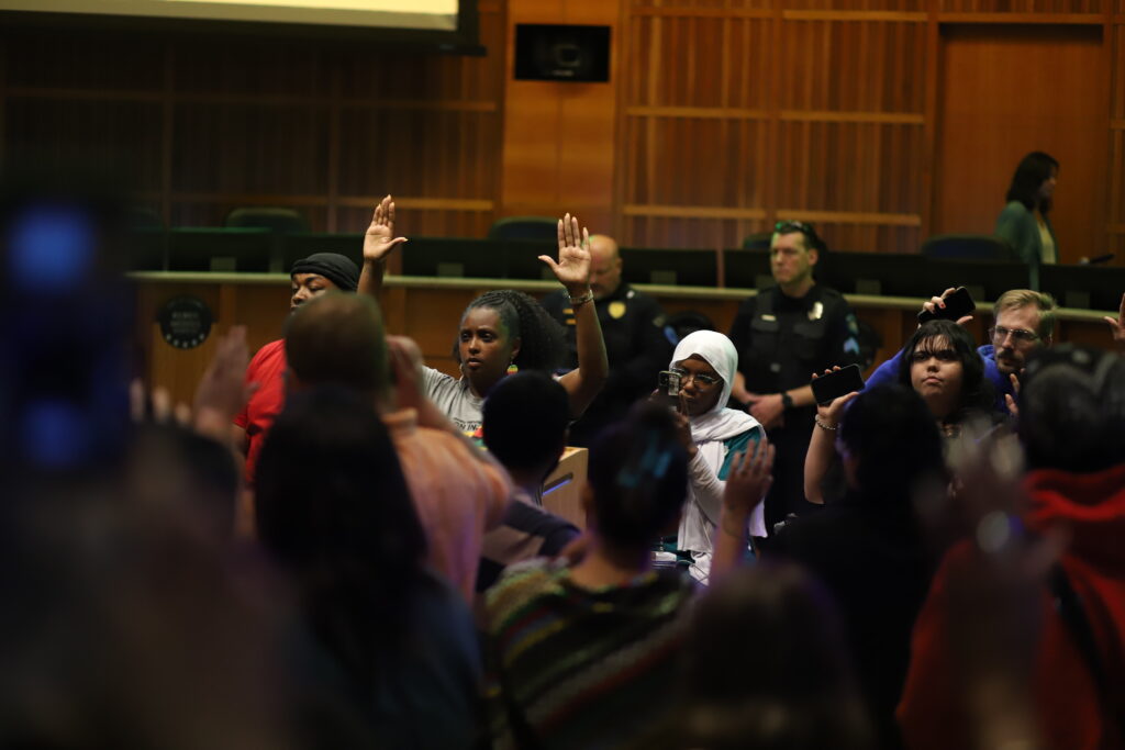 Members of the public protest at an Aurora City Council meeting in July 2024 following the fatal police shooting of Kilyn Lewis.