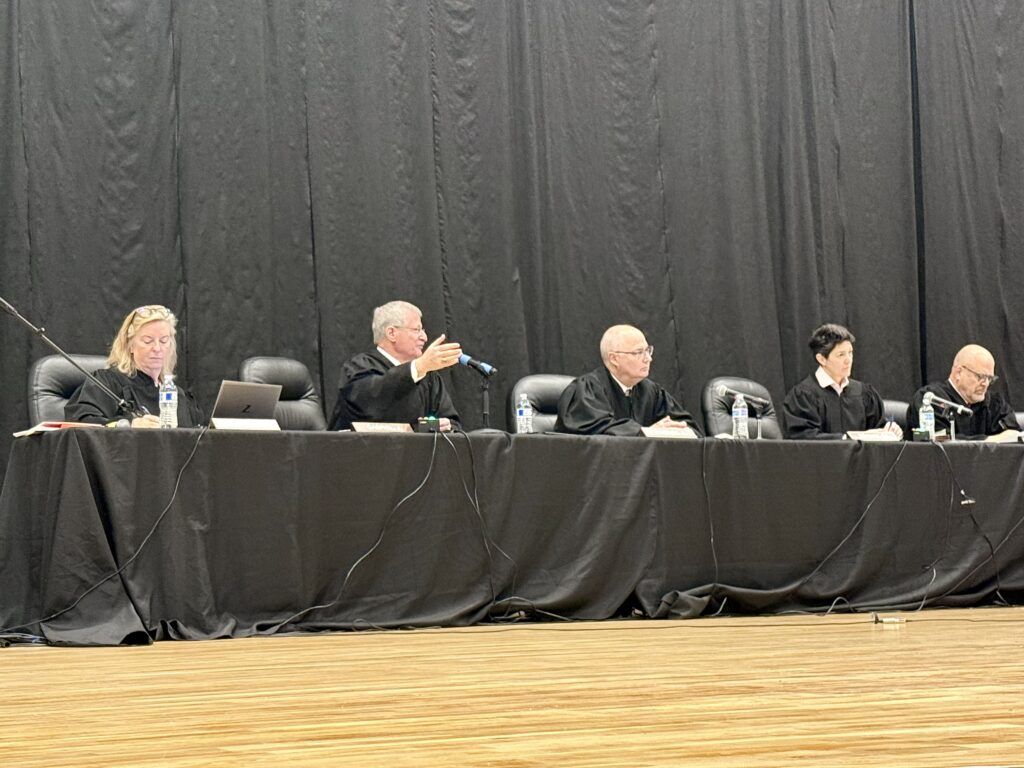 Members of the Colorado Supreme Court participate in oral arguments at Holyoke Junior/Senior High School in Holyoke, Colo. on April 16, 2026 as part of the "Courts in the Community" program. Michael Karlik, Colorado Politics.