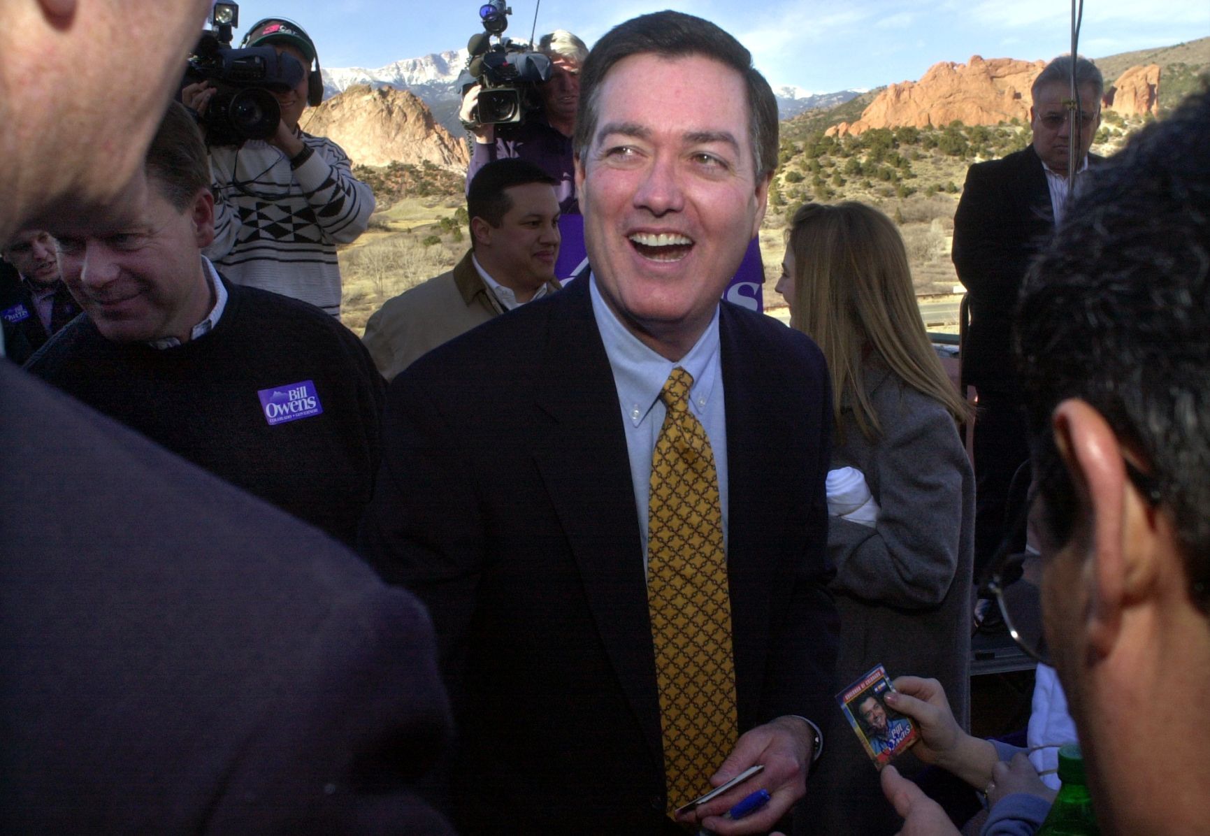 THE DENVER GAZETTE FILE Then-Gov. Bill Owens is surrounded by supporters and media while campaigning in Colorado Springs on Feb. 18, 2002, at Garden of the Gods.