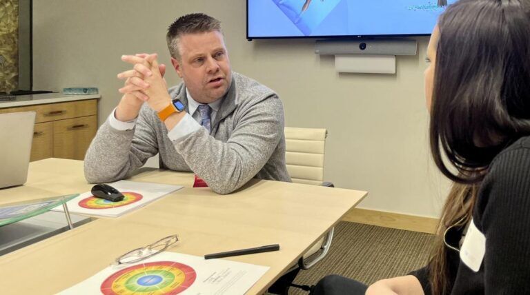FILE PHOTO: Denver District Court Judge Jon J. Olafson speaks with an attorney at the offices of Holland & Hart in Denver on Feb. 26, 2025. The discussion was sponsored by the Colorado Judicial Institute. Michael Karlik/Colorado Politics
