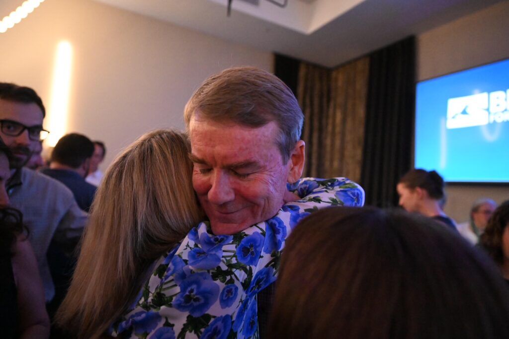 Michael Bennet hugs family after concession speech Tuesday.