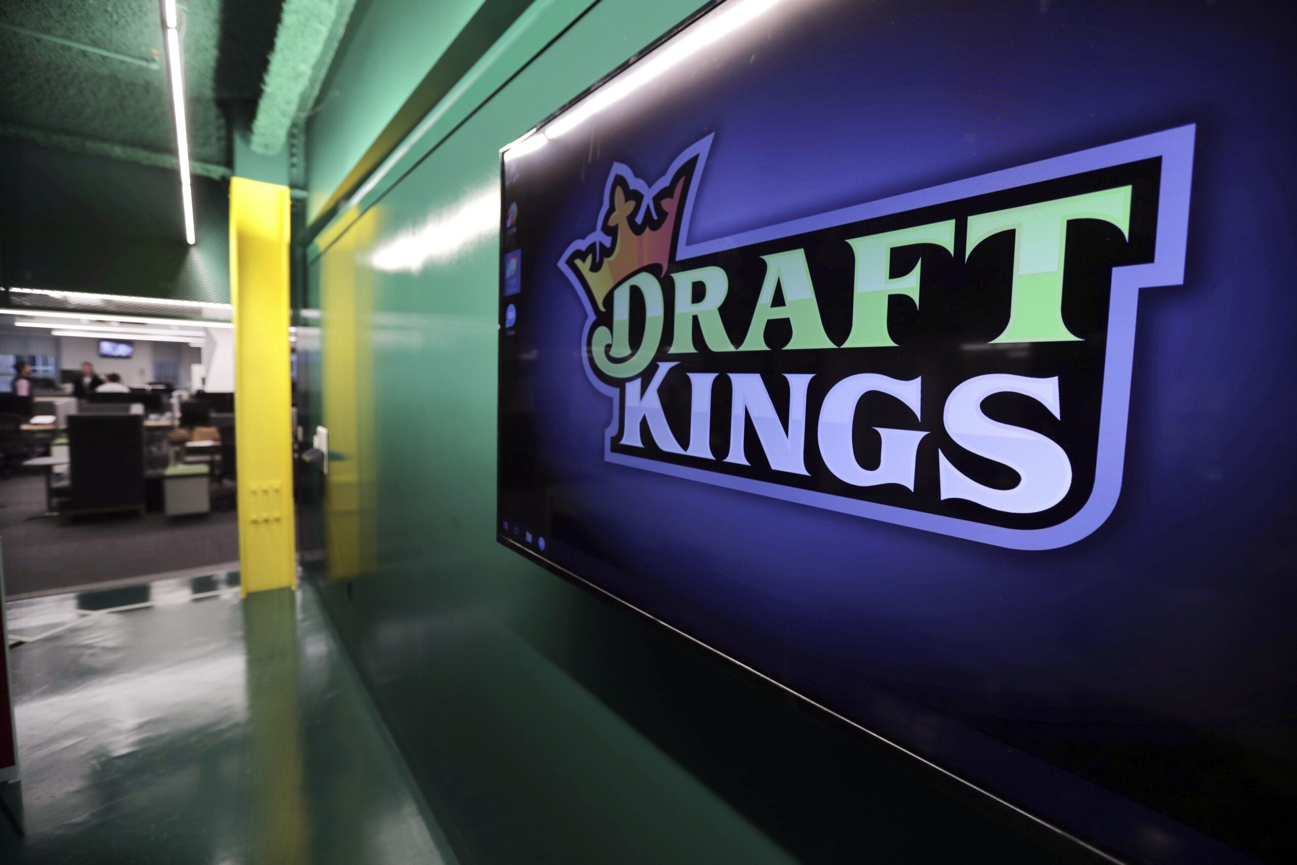 In this May 2, 2019, file photo, the DraftKings logo is displayed at the sports betting company headquarters in Boston. (AP Photo/Charles Krupa, File)