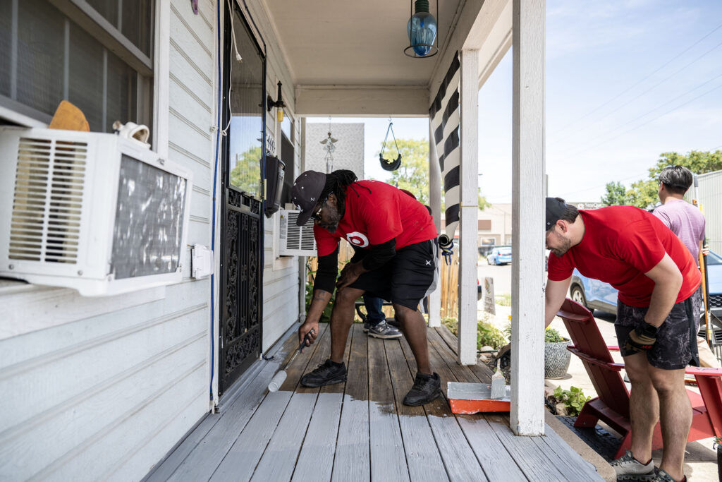 a man refurbishes a deck