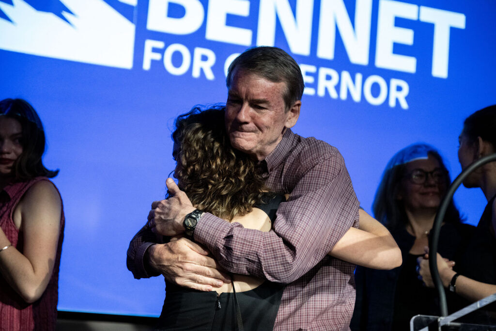 Michael Bennet hugs his family as he concedes his run for governor after losing the Democratic primary race to Phil Weiser on Tuesday, June 30, 2026. (Stephen Swofford, Denver Gazette)