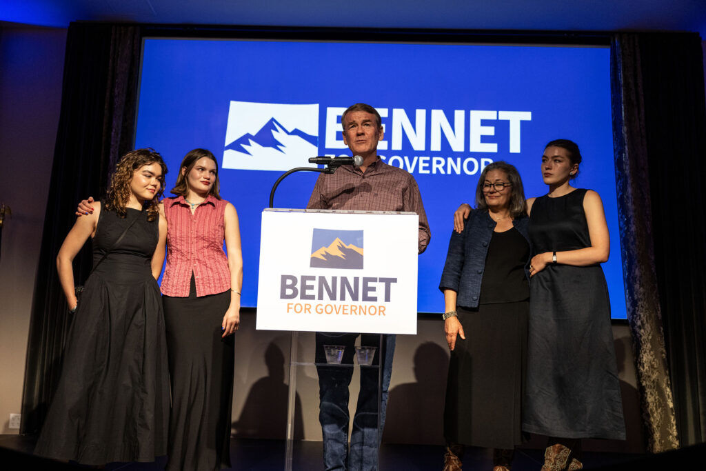 Michael Bennet stands on a dais with his family as he concedes his run for Governor after losing the Democratic primary race to Phil Weiser on Tuesday, June 30, 2026.
(Stephen Swofford, Denver Gazette)
