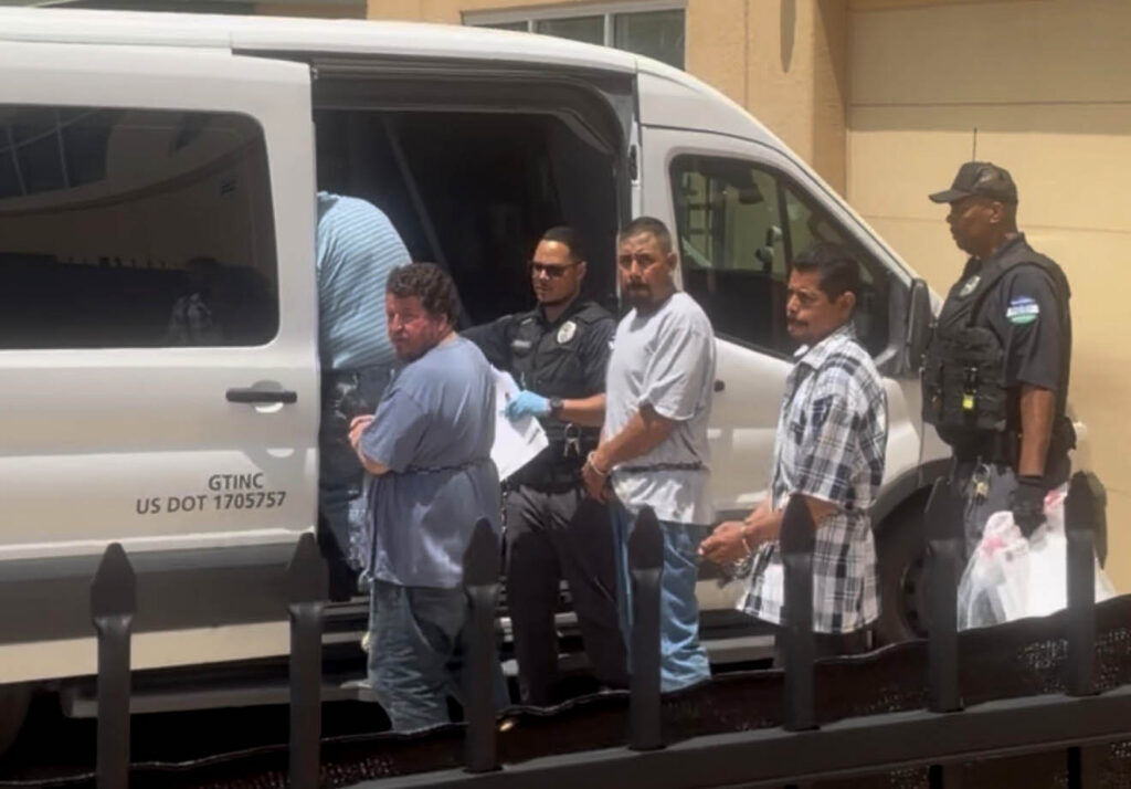 Detainees are loaded into a van at the ICE holding facility in downtown Colorado Springs Thursday, July 9 before being taken to the immigration detention center in Aurora. (Grace Brajkovich, The Gazette)