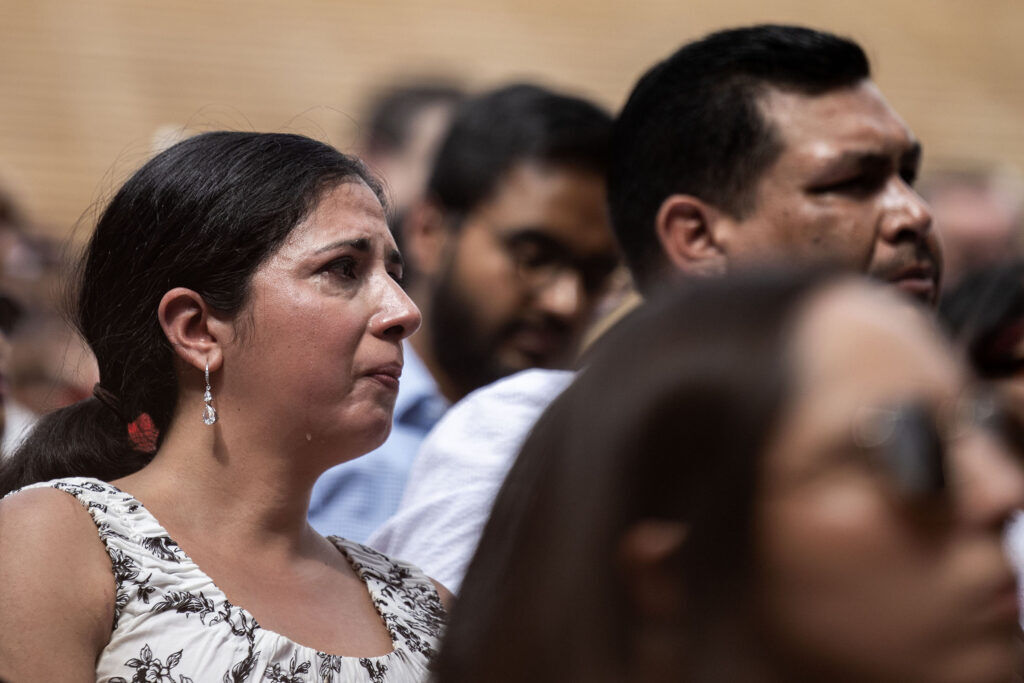 A newly naturalized citizen cries as she listens to the national anthem during a naturalization ceremony at Red Rocks on Thursday, July 30, 2026 in Morrison, Colo.