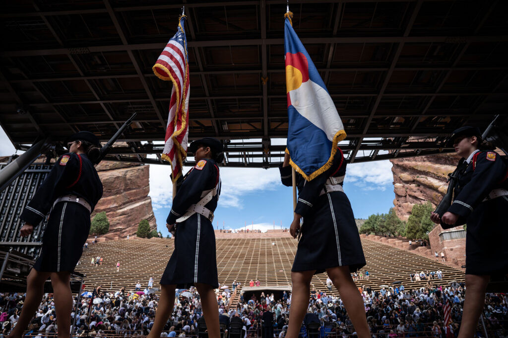 The John F. Kennedy High School Junior ROTC color guard retires the colors during a naturalization ceremony at Red Rocks on Thursday, July 30, 2026 in Morrison, Colo.