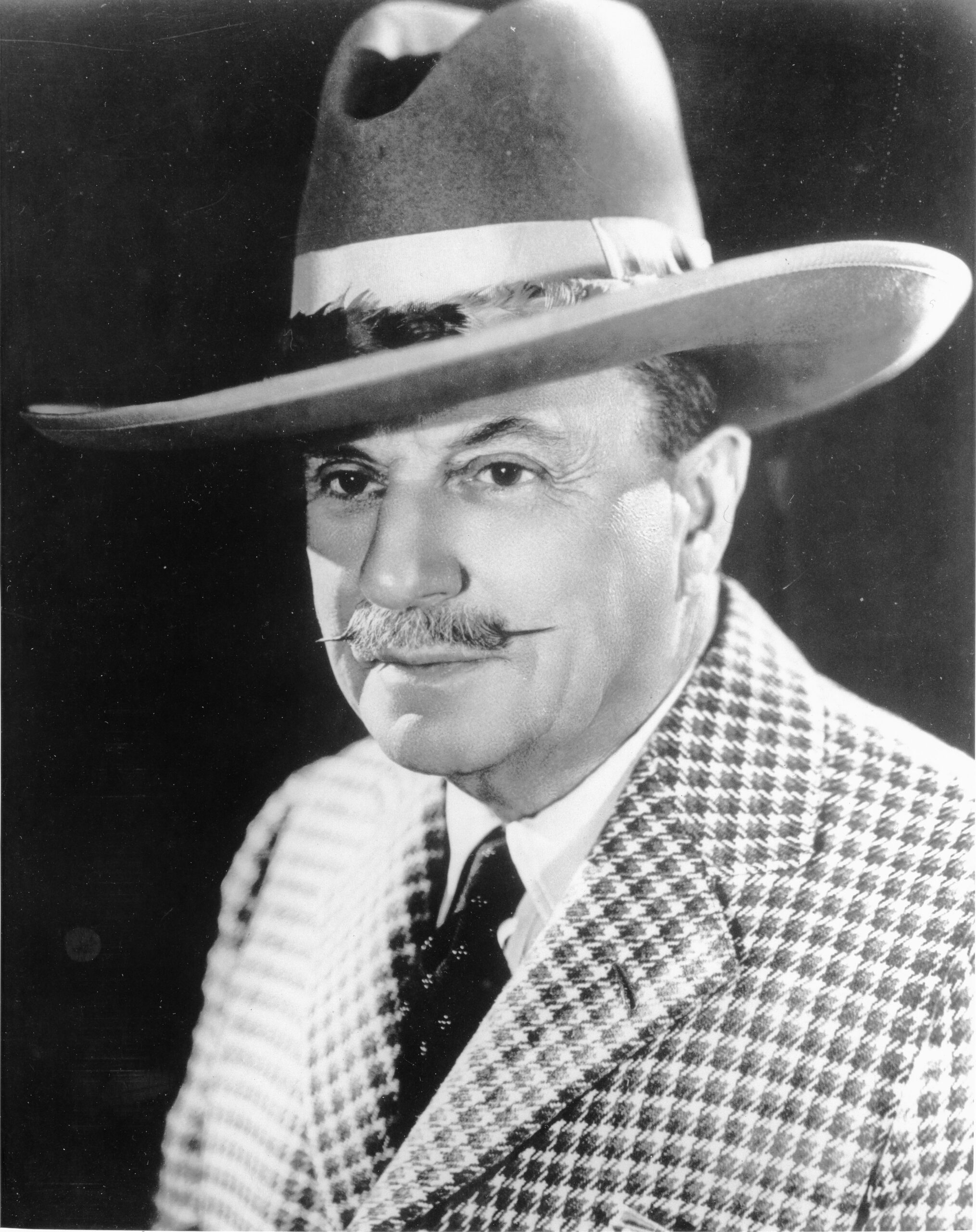 Spencer Penrose in a checkered suit. 