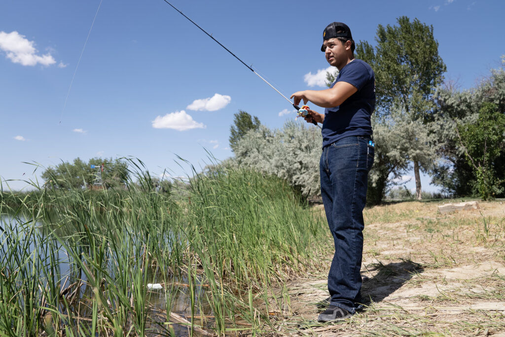 Diego Madera fishes on the Hudson Town Pond on Wednesday, July 15, 2026 in Hudson, Colo. (Tom Hellauer, Denver Gazette)