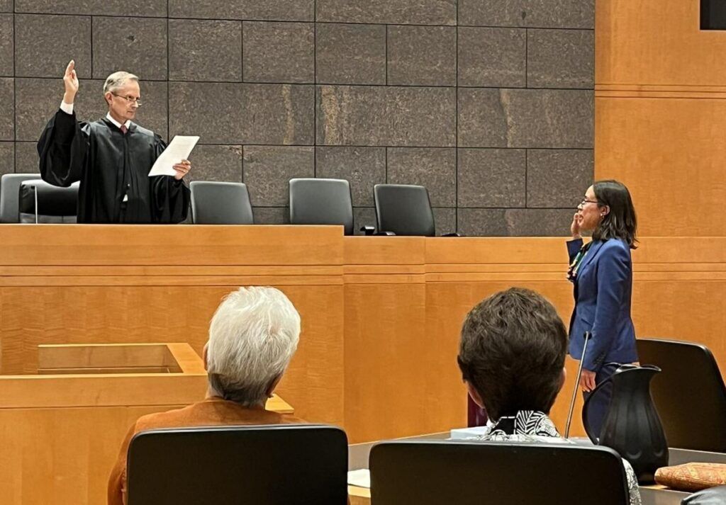 U.S. District Court Chief Judge Philip A. Brimmer swears in U.S. Magistrate Judge Kathryn A. Starnella during her investiture on Oct. 13, 2023. Photo courtsey of Phil Weiser.